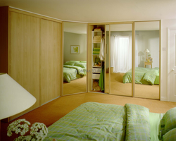 Small bedroom design with corner wardrobe