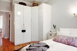 Small bedroom design with corner wardrobe