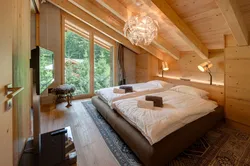 Bedroom Design With A Window In A Wooden House