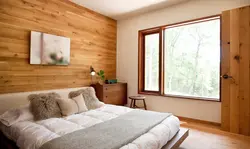 Bedroom design with a window in a wooden house