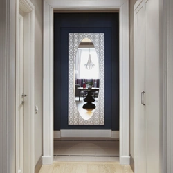 Hallway with a mirror opposite the door photo