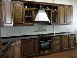 Photo of an oak kitchen with a dark countertop
