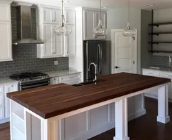 Photo Of An Oak Kitchen With A Dark Countertop