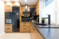 Photo Of An Oak Kitchen With A Dark Countertop