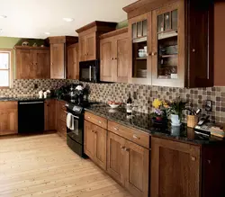 Photo Of An Oak Kitchen With A Dark Countertop