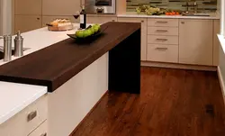 Photo of an oak kitchen with a dark countertop
