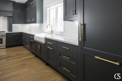 Brown kitchen with white countertops in the interior