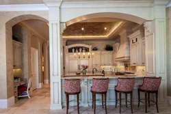 Columns in the interior of a living room with a kitchen