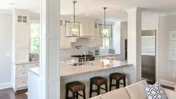 Columns in the interior of a living room with a kitchen