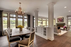 Columns in the interior of a living room with a kitchen