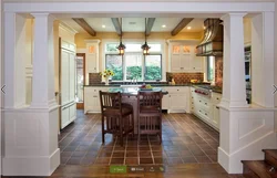 Columns in the interior of a living room with a kitchen