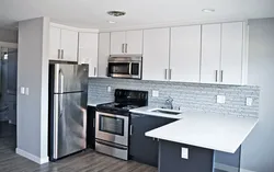 Corner kitchen design with refrigerator by the door