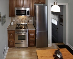 Corner kitchen design with refrigerator by the door