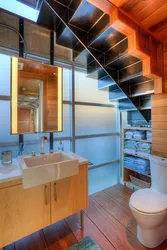 Bathroom design under the stairs in the house