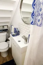 Bathroom design under the stairs in the house
