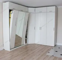 Corner wardrobe with drawers in the bedroom photo