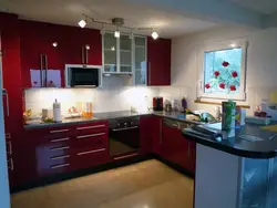 Wallpaper in the interior of a burgundy kitchen