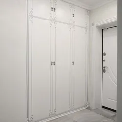 Built-in wardrobe in the hallway with hinged doors design
