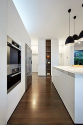Kitchen design with dark floors and light walls