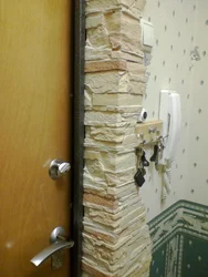 Doorway made of decorative stone in an apartment photo