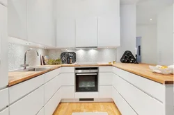 Glossy kitchen with wooden countertops in the interior