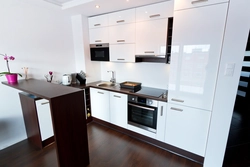 White kitchen with white countertops and white appliances photo