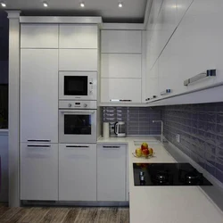 Kitchen design with built-in appliances and refrigerator