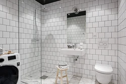Bathtub with white tiles and gray grout photo