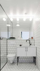 Bathtub with white tiles and gray grout photo