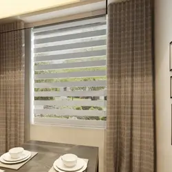 Roller blinds with tulle in the kitchen interior