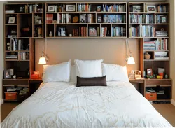 Shelves above the bed in the bedroom photo