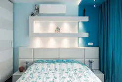 Shelves above the bed in the bedroom photo