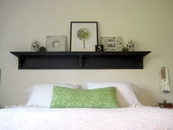 Shelves above the bed in the bedroom photo