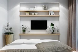 Shelves above the bed in the bedroom photo