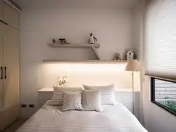 Shelves above the bed in the bedroom photo