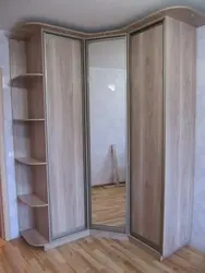 Corner wardrobe for clothes in the bedroom with a mirror photo