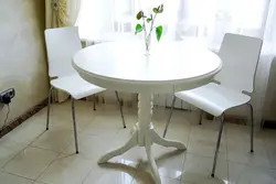 Round table for the kitchen on one leg in the interior