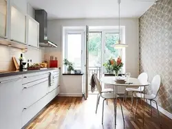 Interior of a rectangular kitchen with access to the balcony