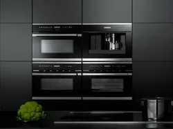 Black household appliances in the kitchen interior