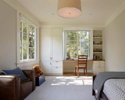 Bedroom design with a window along a long wall