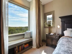 Bedroom design with a window along a long wall