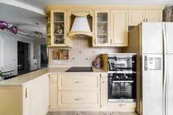 Refrigerator in the corner kitchen photo in the interior