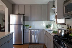 Refrigerator in the corner kitchen photo in the interior