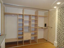 Built-in wardrobe in the living room along the entire wall photo inside