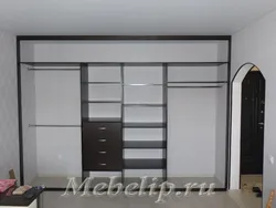 Built-in wardrobe in the living room along the entire wall photo inside