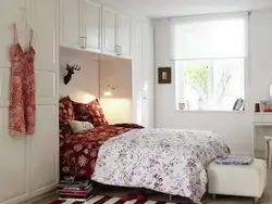 Interior of a small bedroom with one bed