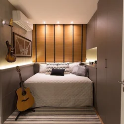 Interior of a small bedroom with one bed