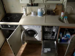 In The Kitchen There Is A Washing Machine And Dishwasher Photo