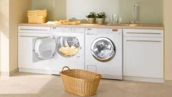 In the kitchen there is a washing machine and dishwasher photo