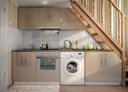 In the kitchen there is a washing machine and dishwasher photo